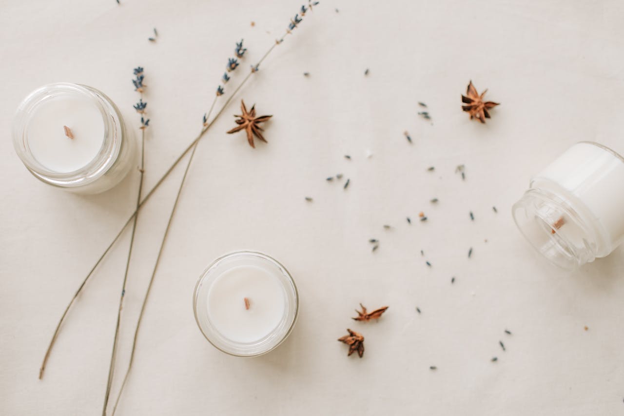 Contact Stylish arrangement of handmade candles with lavender and star anise for a serene ambiance.