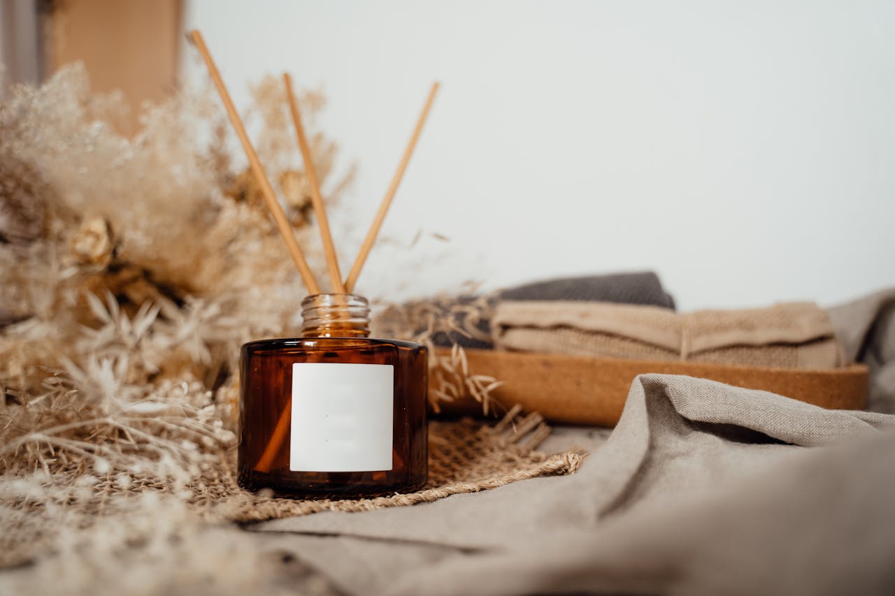 Cozy home display featuring an amber glass diffuser with incense sticks, exuding tranquility.